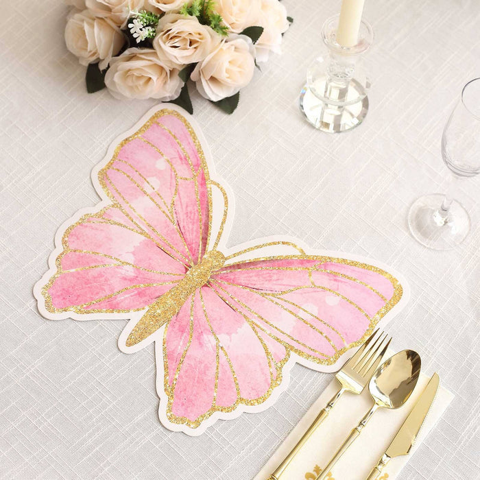 Pink butterfly table placemat with gold glitter accents on a white tablecloth.