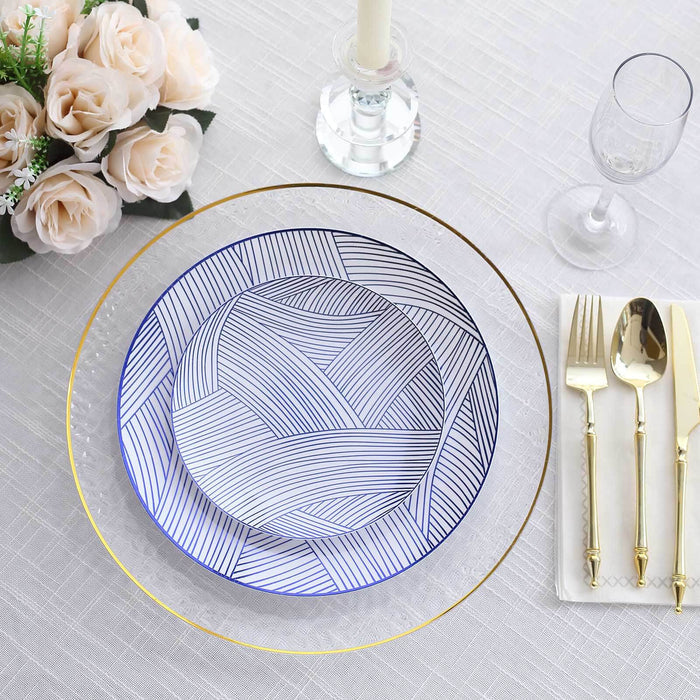Elegant blue and white patterned plates set on a table with gold accents and floral decor.