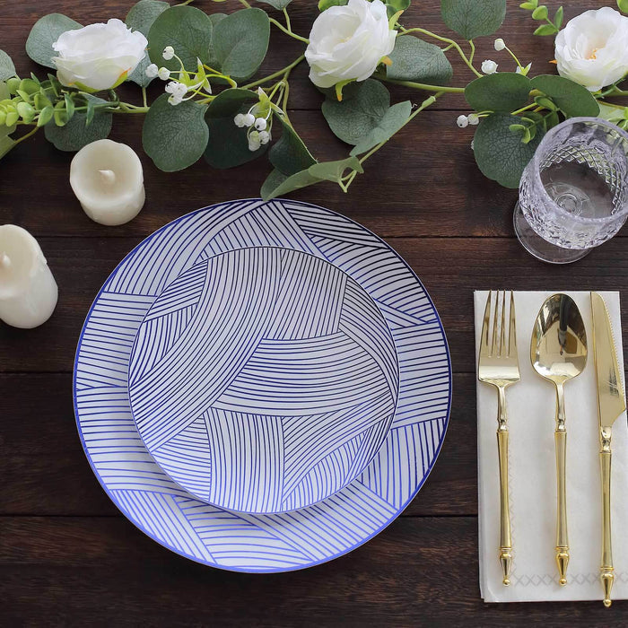 Elegant blue and white patterned plates with gold cutlery and floral decor.