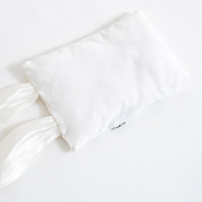 A white sensory bunny pillowcase made of cotton knit with pure silk ears. Inner pillow is made of merino wool, designed as a baby cuddle toy and pillow.