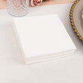White napkins stacked on a table, perfect for events or dining.