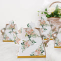 Decorative floral teapot with gold accents on a white backdrop.