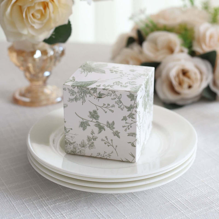 Decorative floral gift box on a white plate with flowers in the background.