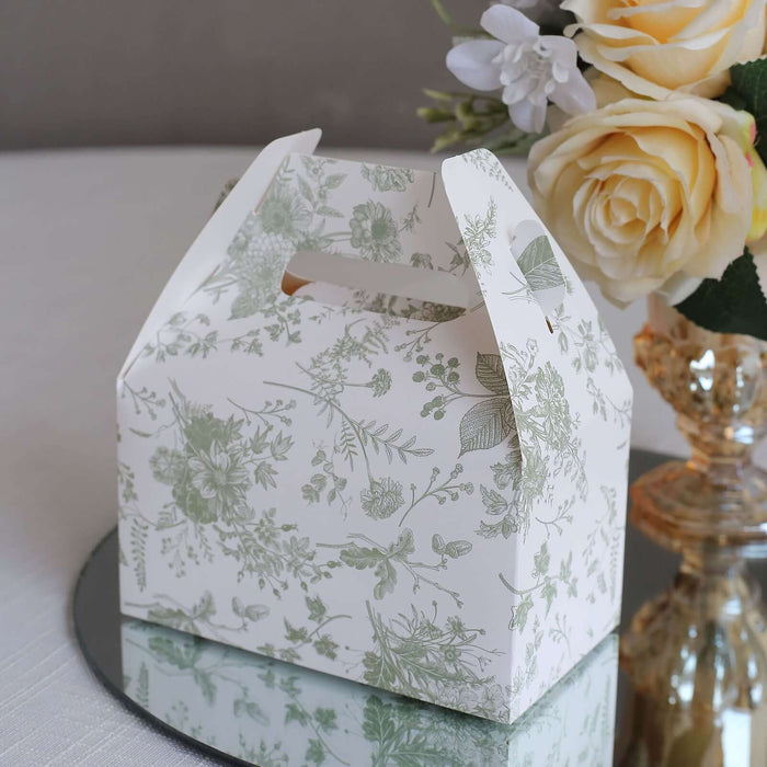 Floral-patterned gift box with handle on a reflective surface.