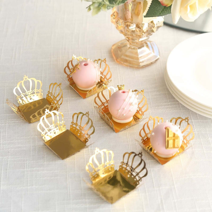 Decorative crown-shaped dessert holders with pink treats.