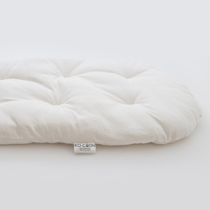 A medium firm flat merino wool baby mattress designed for use in a Moses basket or as a regular size pillow.