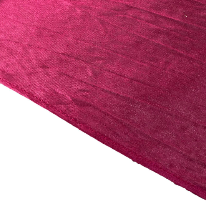 Rich burgundy velvet fabric with a textured surface