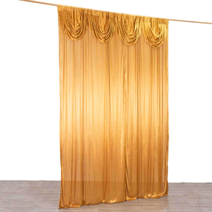 Gold sheer curtain drapes with gathered top design.