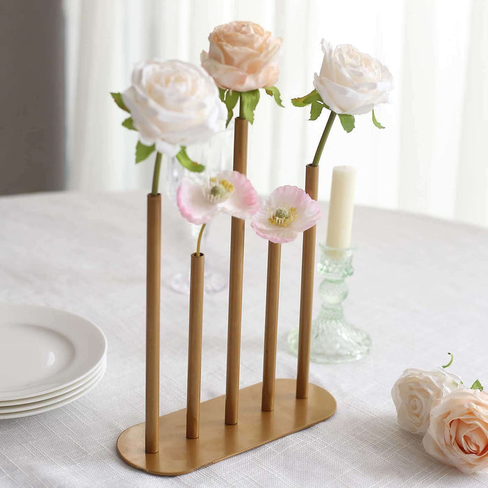Gold flower vase with faux roses and poppies on a table setting.