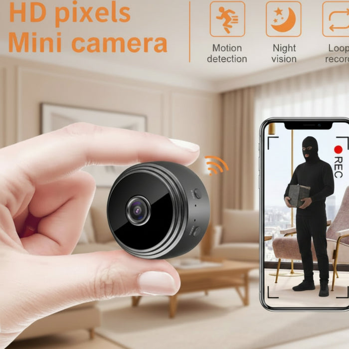 Small black camera held in a hand with smartphone showing recording app interface.