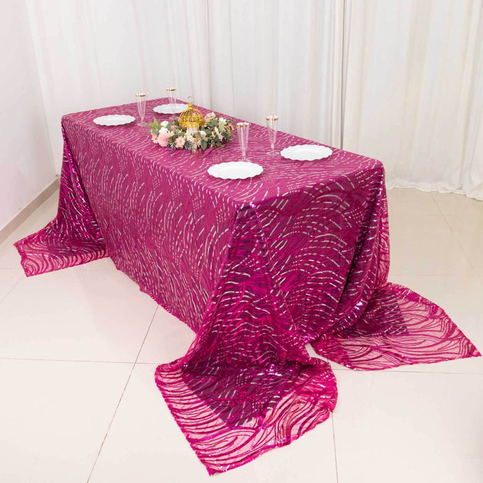 Elegant pink tablecloth with intricate patterns draped over a table.