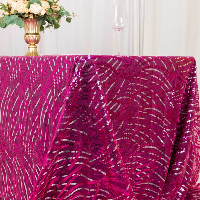 Fuchsia sequin tablecloth draped elegantly over a table with floral centerpiece.