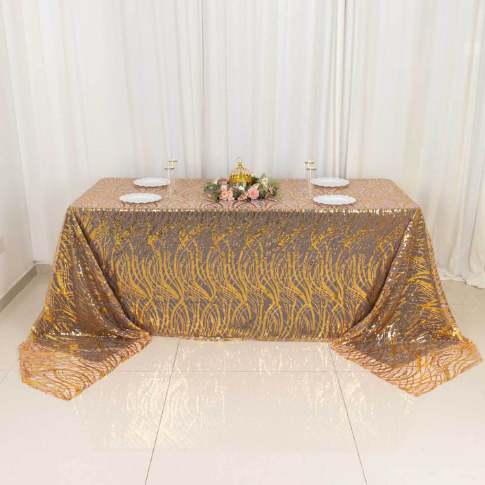 Decorative tablecloth with gold and silver pattern on a dining table.