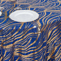Blue and gold sequin tablecloth with wavy patterns and a white plate