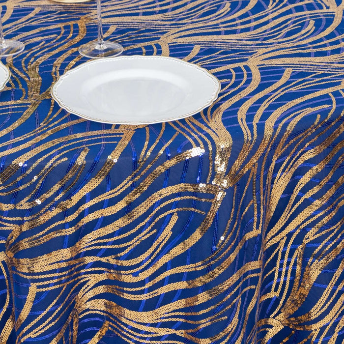 Blue and gold sequin tablecloth with wavy patterns and a white plate