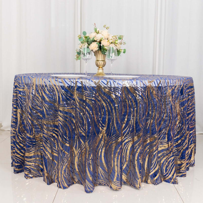Blue and gold patterned tablecloth with floral centerpiece on a round table.