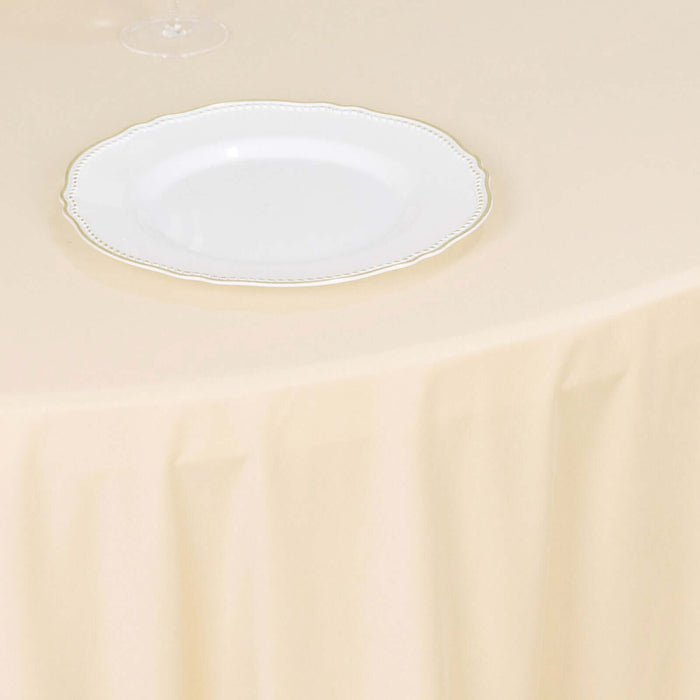 Elegant white plate with gold trim on a soft beige tablecloth.