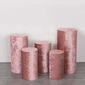 Pink velvet pedestals in various heights on a plain background.