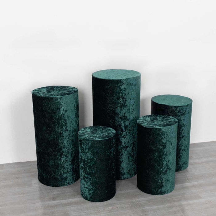 Green velvet cylindrical display pedestals in various heights