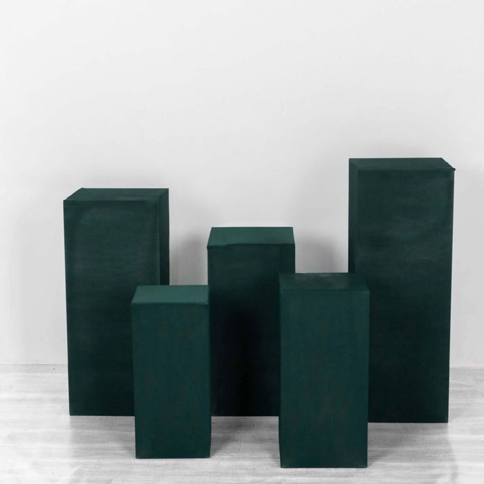 Green display pedestals in various heights on a white backdrop