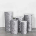 Set of five decorative gray pedestals in various heights and shapes.
