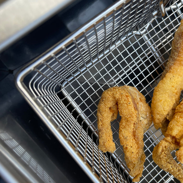 Close up image of Bayou Fryer basket and fried fish
